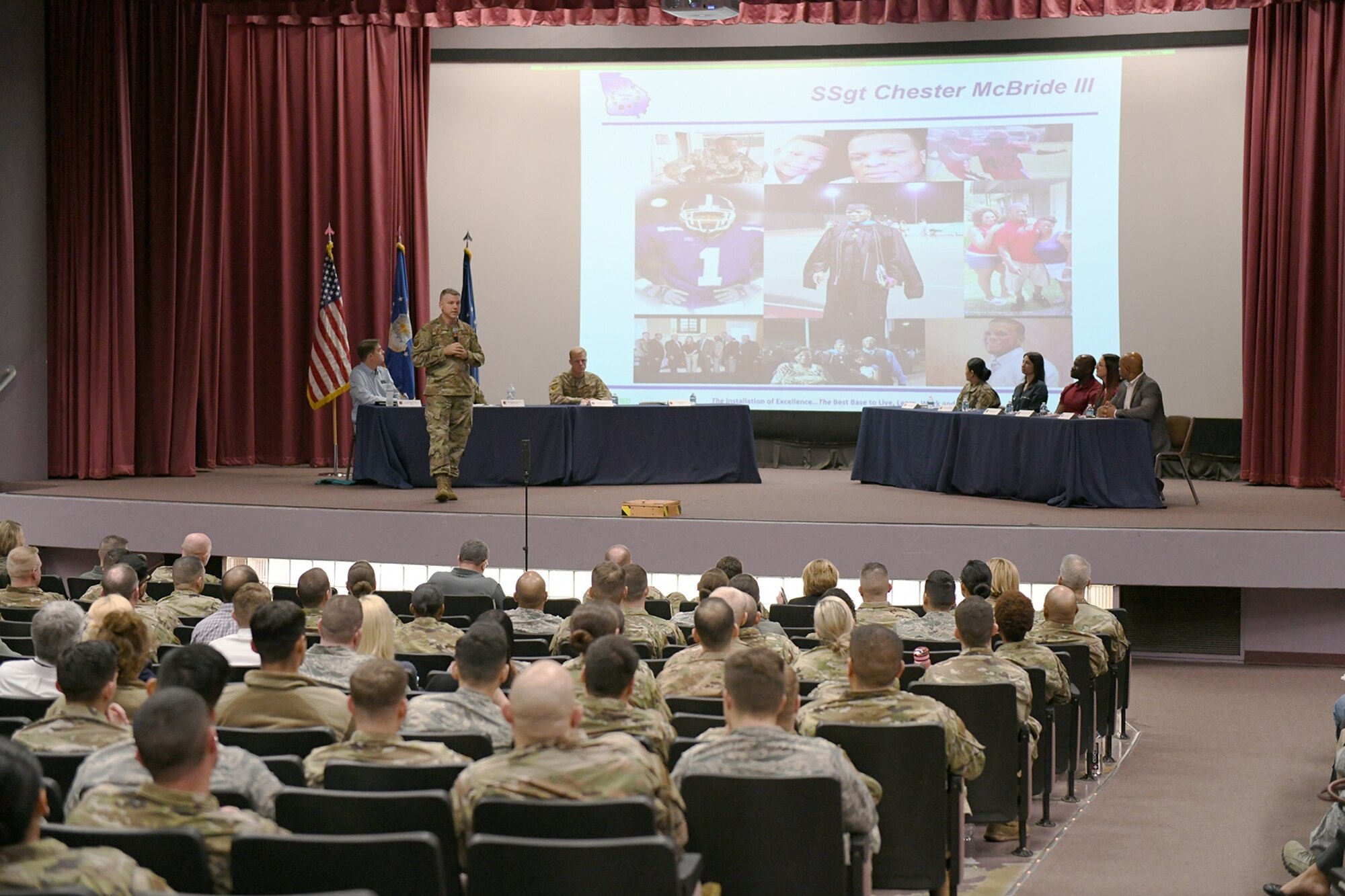 Col. Brian Moore, 78th Air Base Wing commander, Robins Air Force Base, Ga., addresses attendees during the Robins Proud Forum at the base theater, Feb. 25, 2020. Col. Moore told the heroic story of Office of Special Investigations Special Agent Chester McBride during the event. The commander recognizes local Gold Star families and their loved ones during the monthly gatherings. The forums allow leadership and subject matter experts to communicate face-to-face and interact with Team Robins members on topical issues, such as resiliency and readiness. (U.S. Air Force photo by Rodney Speed, 78 ABW/PA)