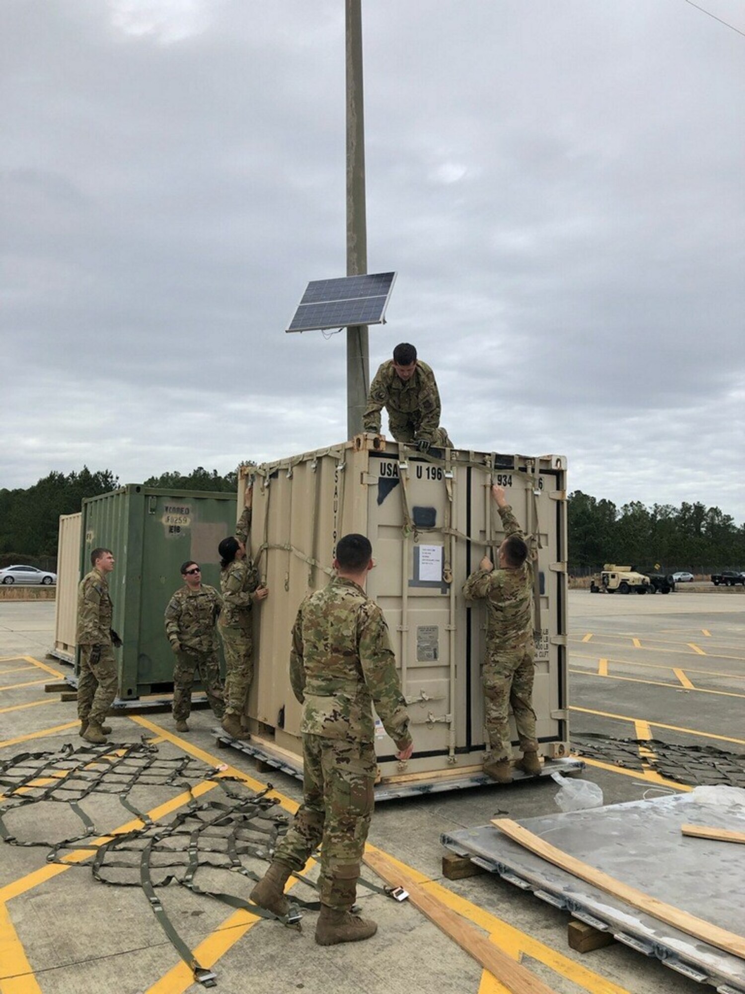 EAGLE team members properly secure a container to a 463L pallet using top and side netting at Pope Army Airfield, N.C., Jan. 10, 2020. The EAGLE team provided support for the 82nd Airborne Division's Immediate Response Force deployment to the Middle East.