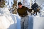 A U.S. Marine digs a fighting position during cold-weather training near Bjerkvik, Norway, Feb. 23.