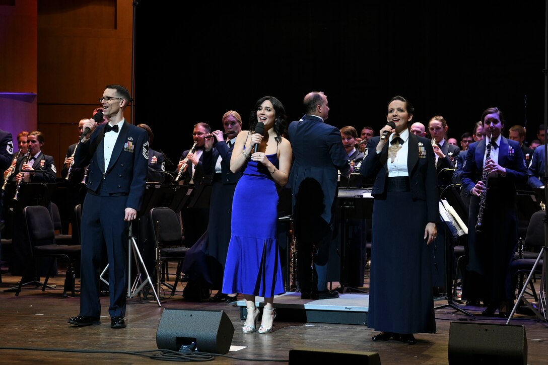 Senior Master Sgt. Matthew Irish, superintendent of outreach for The U.S. Air Force Band, Samantha Massell, singer, and Master Sgt. Emily Wellington, Singing Sergeants alto vocalist sing together during the band’s Guest Concert Series at the Rachel M. Schlesinger Concert Hall and Arts Center in Alexandria, Va., Feb. 20, 2020. The concert featured a lineup of more than 10 songs including pieces from “The Sound of Music” and Walt Disney’s “Pocahontas”. (U.S. Air Force photo by Airman 1st Class Spencer Slocum)