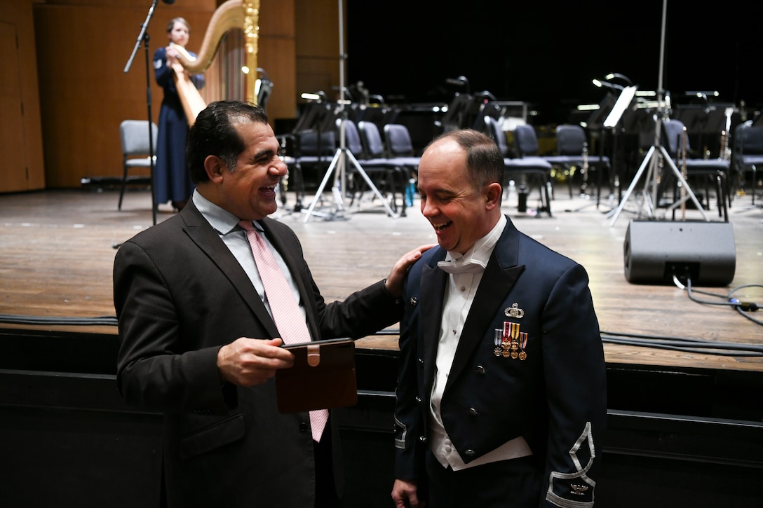 Col. Don Schofield, The United States Air Force Band commander and conductor, shares a laugh with a concert attendee before the Guest Concert Series at the Rachel M. Schlesinger Concert Hall and Arts Center in Alexandria, Va., Feb. 20, 2020. The concert featured the United States Air Force Concert Band, members of the Singing Sergeants and their guest performer, Samantha Massell. (U.S. Air Force photo by Airman 1st Class Spencer Slocum)