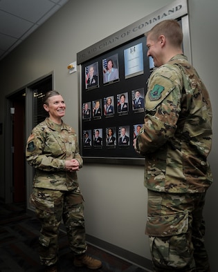 Chief Master Sgt. Stacy Wilfong, Headquarters Readiness and Integration Organization command chief, talks to Master Sgt. Kevin Wilson, noncommissioned officer in charge of installation personnel readiness at RIO, in the hallway of RIO, March 3, 2020. Wilfong was selected in February to be HQ RIO's command chief and began her duties March 2. (U.S. Air Force photo by Master Sgt. Leisa Grant/Released)