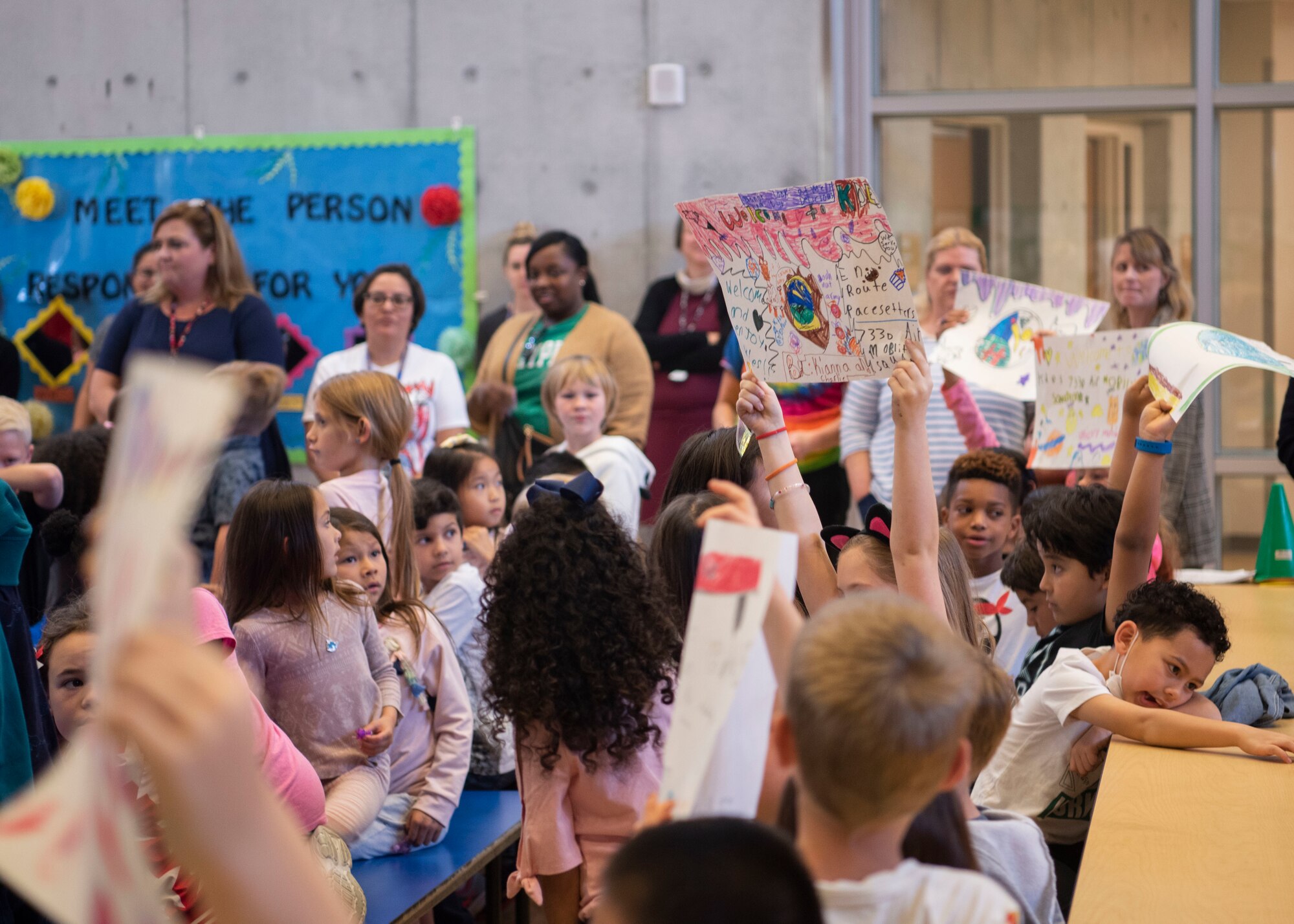 Members from the 733rd Air Mobility Squadron and students from Kadena Elementary School gather for an Adopt-a-School Program ceremony at KDES.