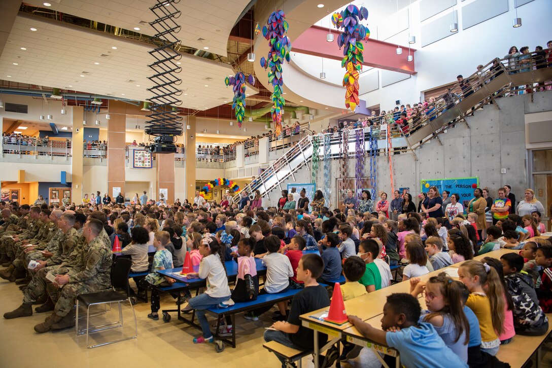 Members from the 733rd Air Mobility Squadron and students from Kadena Elementary School gather for an Adopt-a-School Program ceremony at KDES.