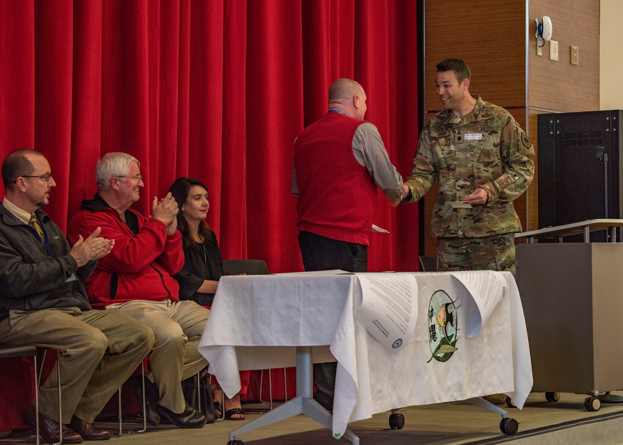 Members from the 733rd Air Mobility Squadron and students from Kadena Elementary School gather for an Adopt-a-School Program ceremony at KDES.