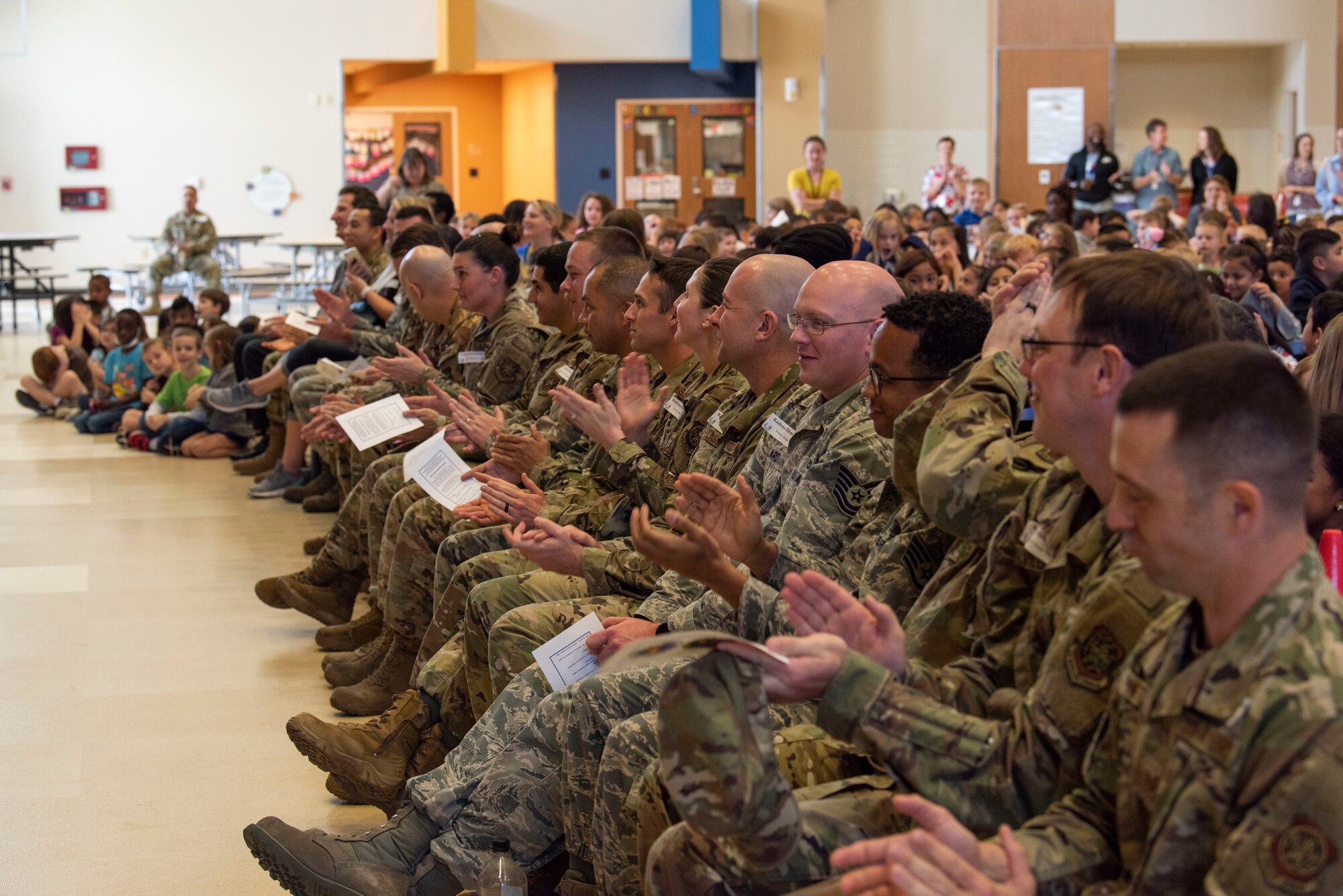 Members from the 733rd Air Mobility Squadron and students from Kadena Elementary School gather for an Adopt-a-School Program ceremony at KDES.