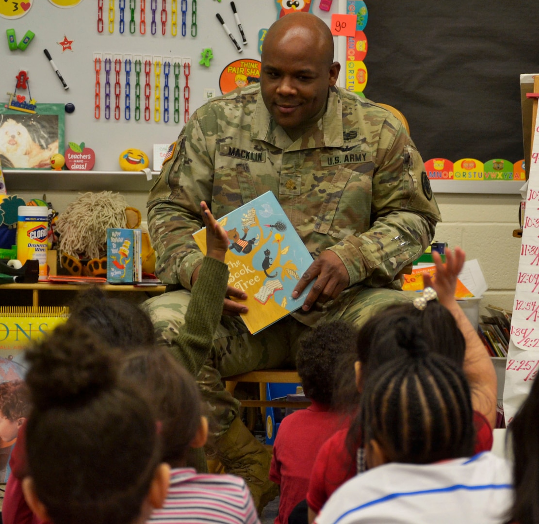 A US Army soldier reads to school children during Read Across America Day.