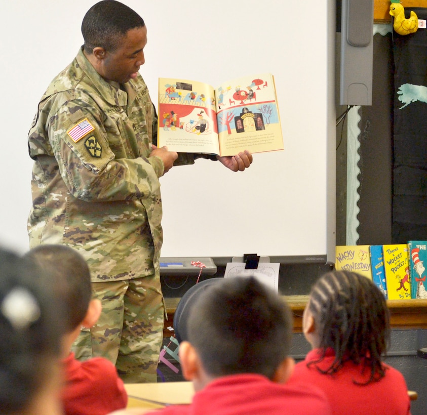 A US Army Soldier reads to school children during National Read Across America Day.