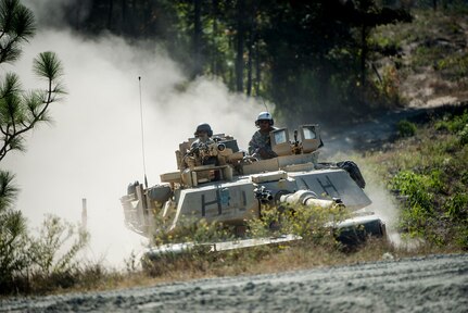 In an October 2016 photo, an M1A2 Abrams tank moves with agility through rugged, wooded terrain during a combat training exercise at Fort Benning, Ga. Fort Benning will host the arduous Sullivan Cup Tank Crew Competition May 4-8.