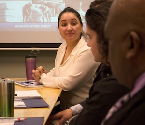 Gabriela Moraga, a Medical tailored vendor logistics specialist, listens during a presentation for a Joint Special Operations Command team at DLA Troop Support Feb. 28, 2020 in Philadelphia.