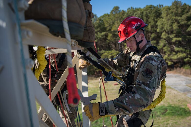 A U.S. Air Force Airman climbs a training tower.