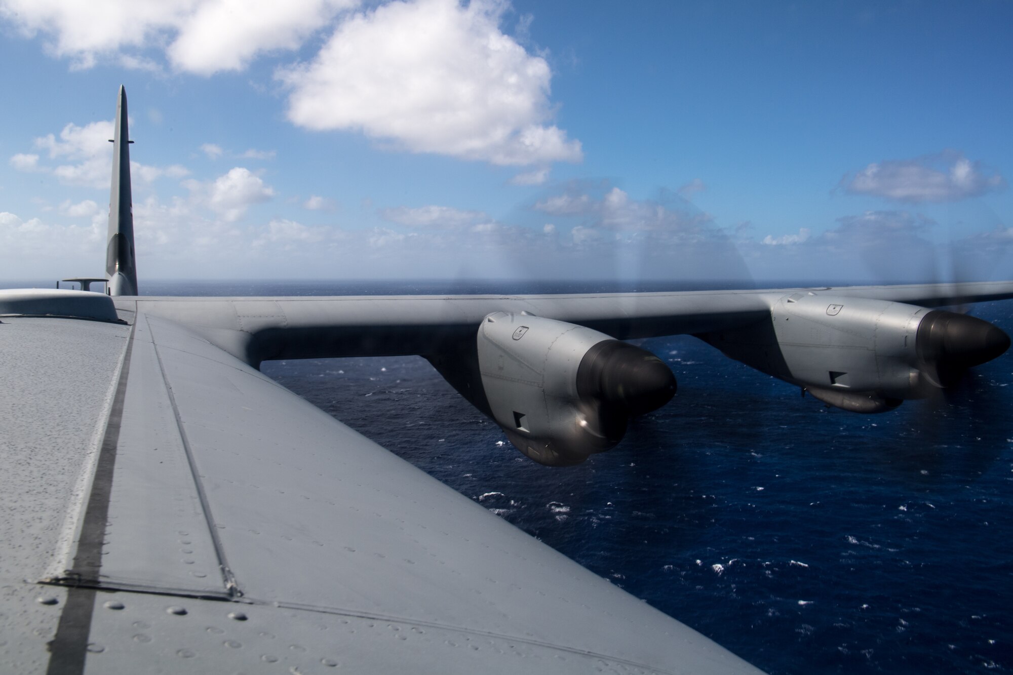 A C-130J Super Hercules flies over the Pacific Ocean for an airdrop of container delivery systems over Tinian during Exercise Cope North 20, Feb. 24, 2020, Andersen Air Force Base, Guam. Cope North 20 is an annual trilateral field training exercise conducted at Andersen Air Force Base, Guam, and around the Commonwealth of the Northern Mariana Islands (CNMI), Palau and Yap in the Federated States of Micronesia. (U.S. Air Force photo by Senior Airman Gracie Lee)