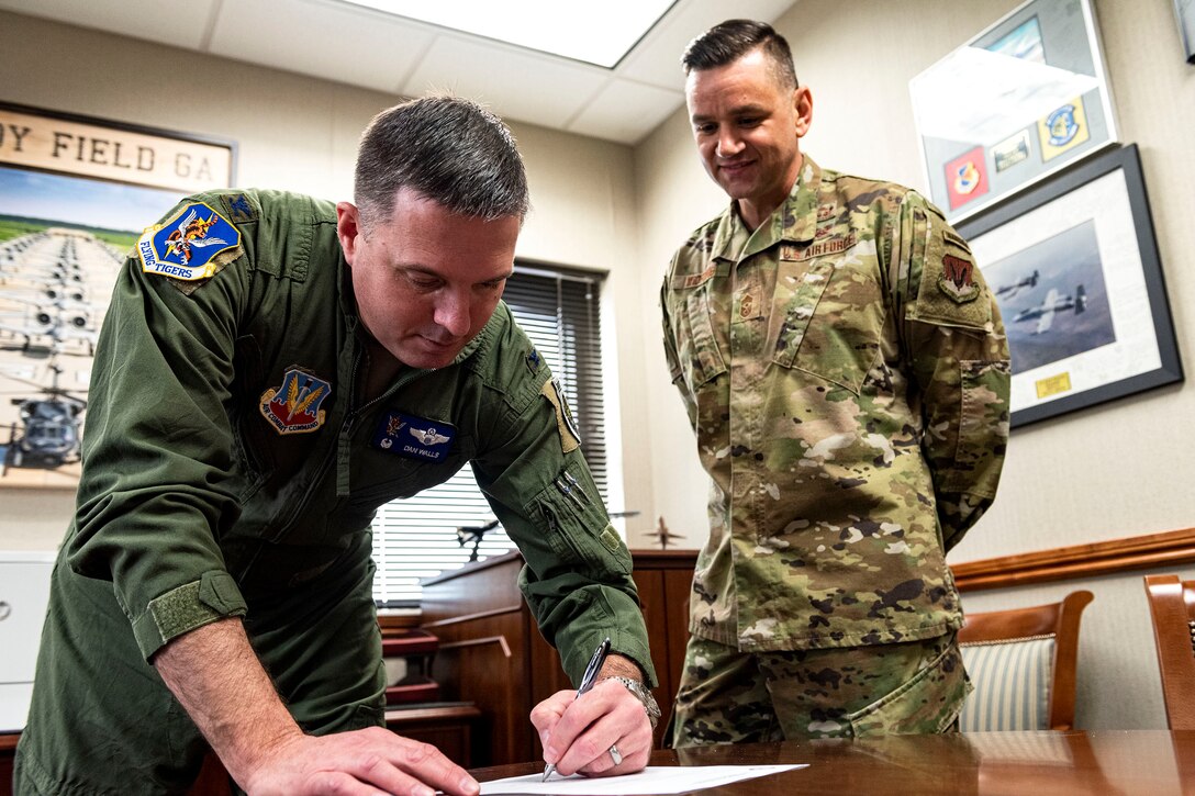 Photo of 23d Wing leadership signing an endorsement.