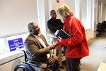 Retired U.S. Army Col. Gregory Gadson exchanges words with Dr. Maureen Foley on Feb. 24, 2020, in West Bethesda, Md.