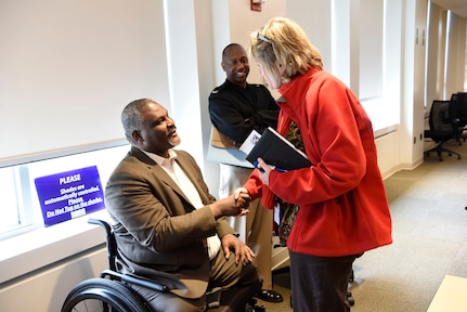 Retired U.S. Army Col. Gregory Gadson exchanges words with Dr. Maureen Foley on Feb. 24, 2020, in West Bethesda, Md.