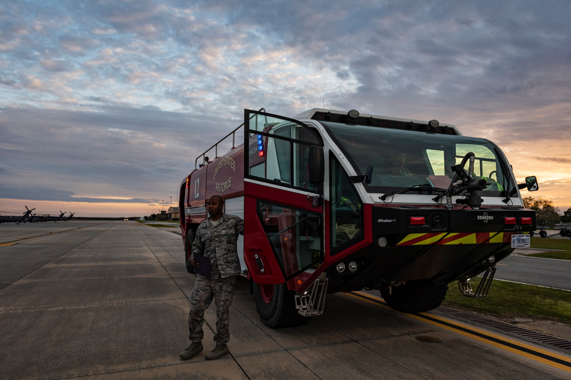 A photo of an Airman stepping out of a firefighting vehicle