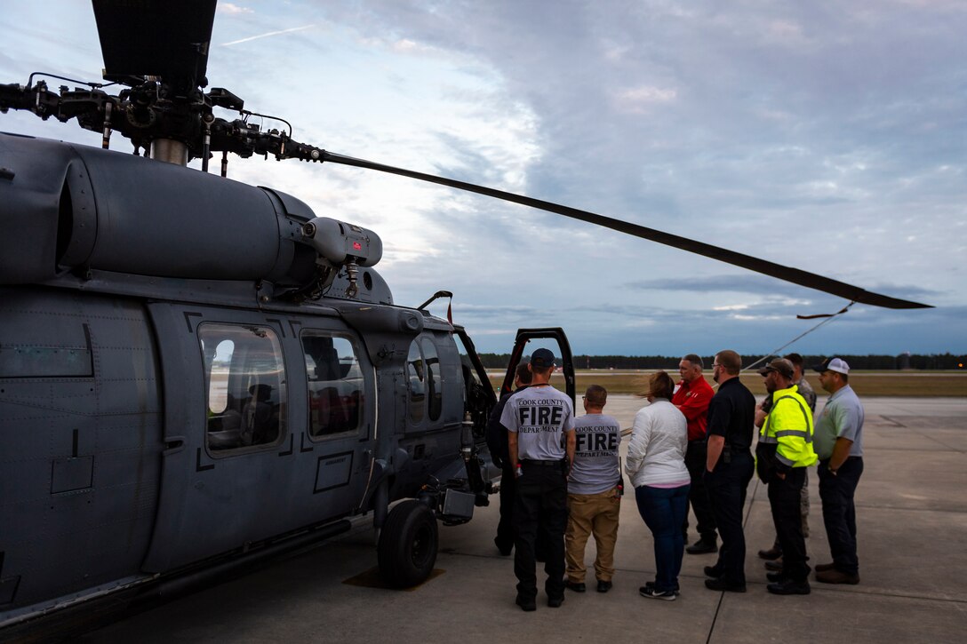 A photo of firefighters touring a helicopter