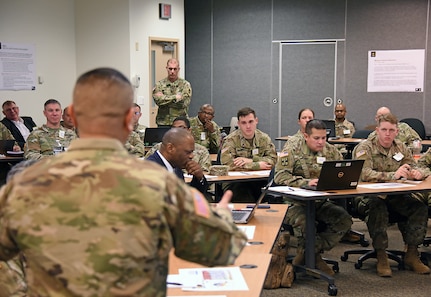 Participants in the medical maintenance function work group listen as Chief Warrant Officer 5 Jesus Tulud, left, discusses challenges to the enterprise on Feb. 24 during a table top exercise hosted by Army Medical Logistics Command at Fort Detrick, Md.