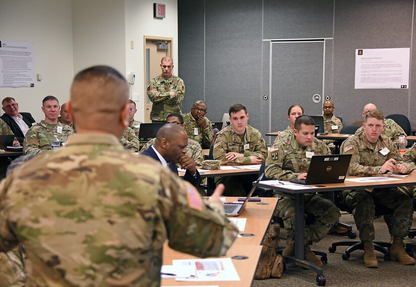 Participants in the medical maintenance function work group listen as Chief Warrant Officer 5 Jesus Tulud, left, discusses challenges to the enterprise on Feb. 24 during a table top exercise hosted by Army Medical Logistics Command at Fort Detrick, Md.