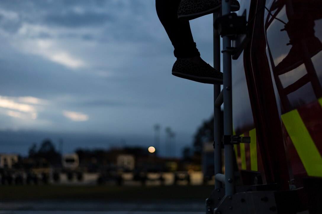 A photo of a local firefighter stepping off of a vehicle