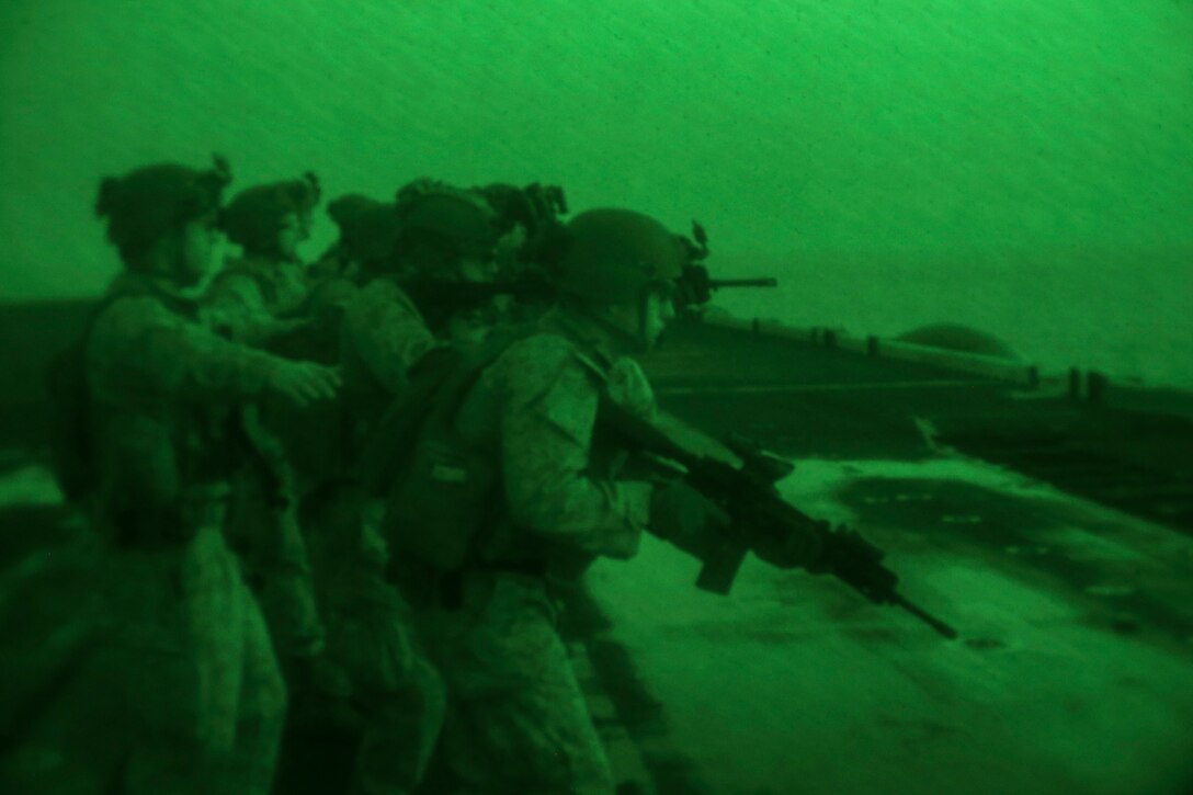200301-M-KE756-1020 GULF OF OMAN (March 1, 2020) Marines assigned to Fox Company, Battalion Landing Team, 2nd Battalion, 8th Marine Regiment, 26th Marine Expeditionary Unit (MEU), move to the next firing line during a live-fire training range aboard the amphibious assault ship USS Bataan (LHD 5) March 1, 2020. Bataan, with embarked 26th MEU, is deployed to the U.S. 5th Fleet area of operations in support of naval operations to ensure maritime stability and security in the Central Region, connecting the Mediterranean and Pacific through the Western Indian Ocean and three strategic choke points. (U.S. Marine Corps photo by Cpl. Tanner Seims)