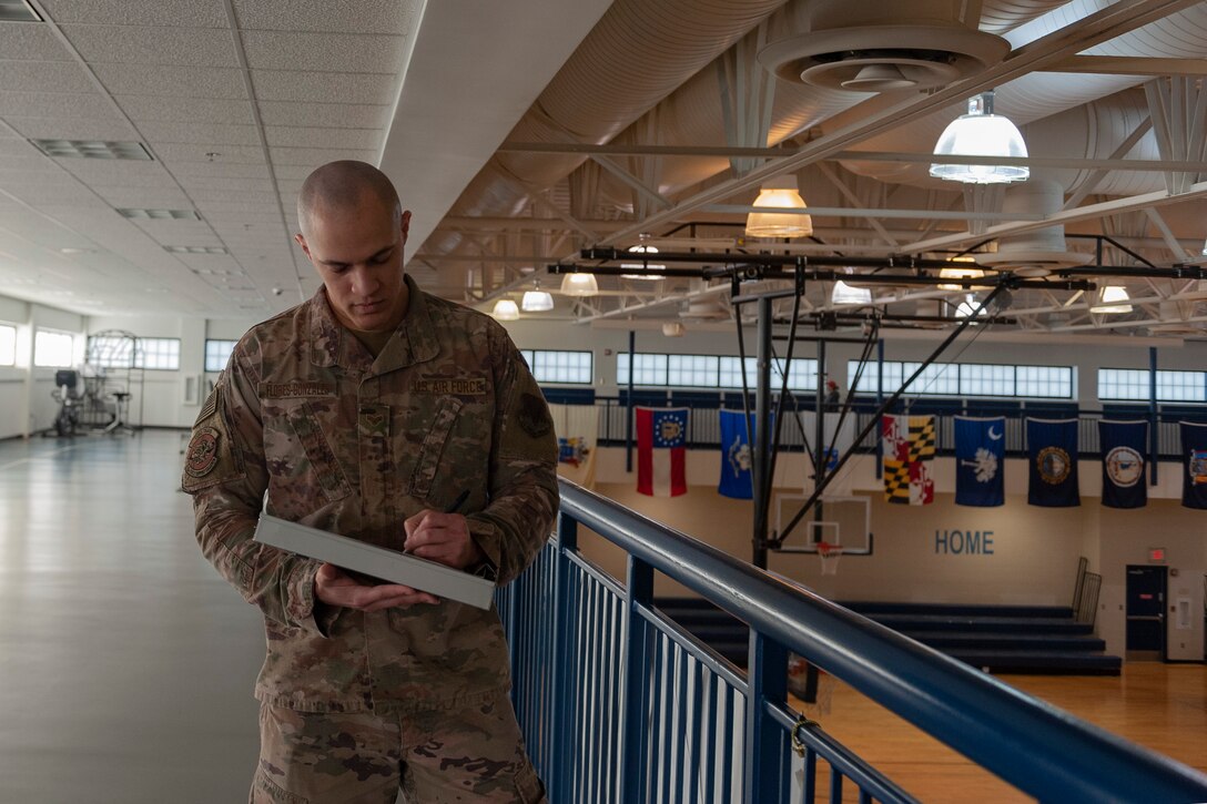 Photo of Airman recording head count results