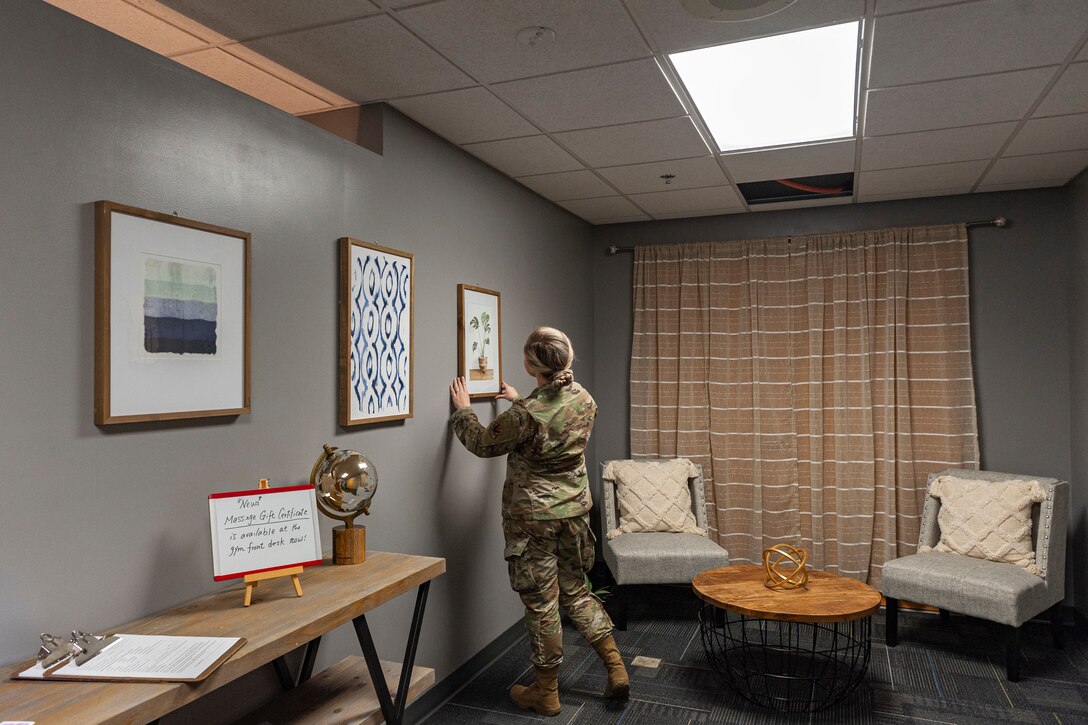 Photo of Airman hanging a picture