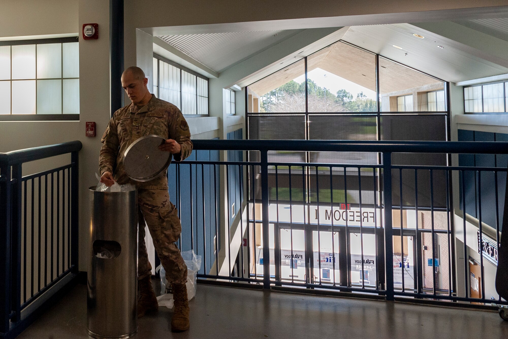 Photo of Airman replenishing sanitation wipes