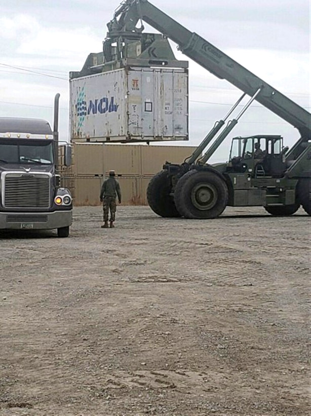 Soldiers from the 101st Airborne Division (Air Assault), work together to move a container of material that is part of Operation Eagle Sweep.