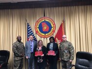 From left to right, Marine Corps Logistics Base Albany Sgt. Maj. Jeffrey Young, Executive Director Leonard Housley and Executive Officer Lt. Col. Joseph Ray hand out awards during the Commanding Officer’s Safety Council Feb. 19. Award recipients from left to right, MCCS Safety Officer Alisha Montieth and MCCS Director Deborah Bouyer received the CO’s Safety Division CY19 Award for the 4th Quarter and the CY19 Award of the Year. (U.S. Marine Corps by Juan Escovar)