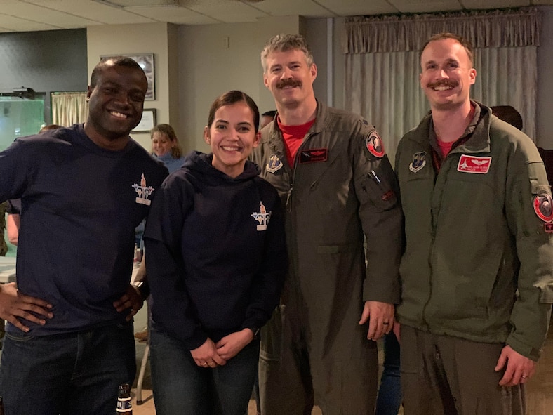 Staff Sgt. Shemron Ross, Airman 1st Class Mabell Teixeira, Lt. Col. Andrew “Shotgun” Avery, and Maj. Mark “Mr. Chow” Silvers (Left to right) take a photo after a friendly competition of a game of Jenga during the 104th Fighter Wing Officers vs. Enlisted Olympics, Feb. 1, 2020. The games brought the wing’s team members together for camaraderie. (U.S. Air National Guard Photo by Senior Master Sgt. Julie Avey)