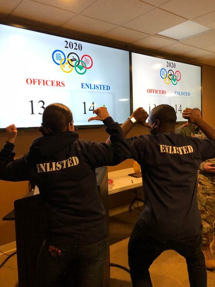 Airman 1st Class Mabell Teixeira and Staff Sgt. Shemron Ross of the 104th Force Support Squadron, celebrate after they won the 104th Fighter Wing’s Officer vs. Enlisted Olympics, Feb. 1, 2020. Teixeira and Ross won the final game of the night and the trophy for the enlisted. The friendly competition brought wing members together to share camaraderie during their February unit training assembly. (U.S. Air National Guard Photo by Senior Master Sgt. Julie Avey)