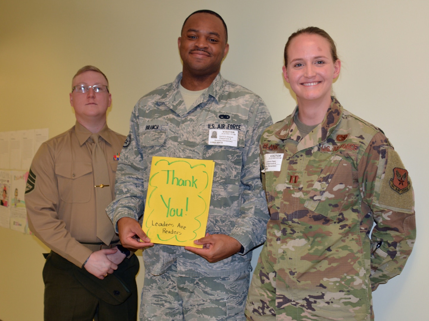 DLA Aviation military members pose with thanks you card given to them by elementary school students