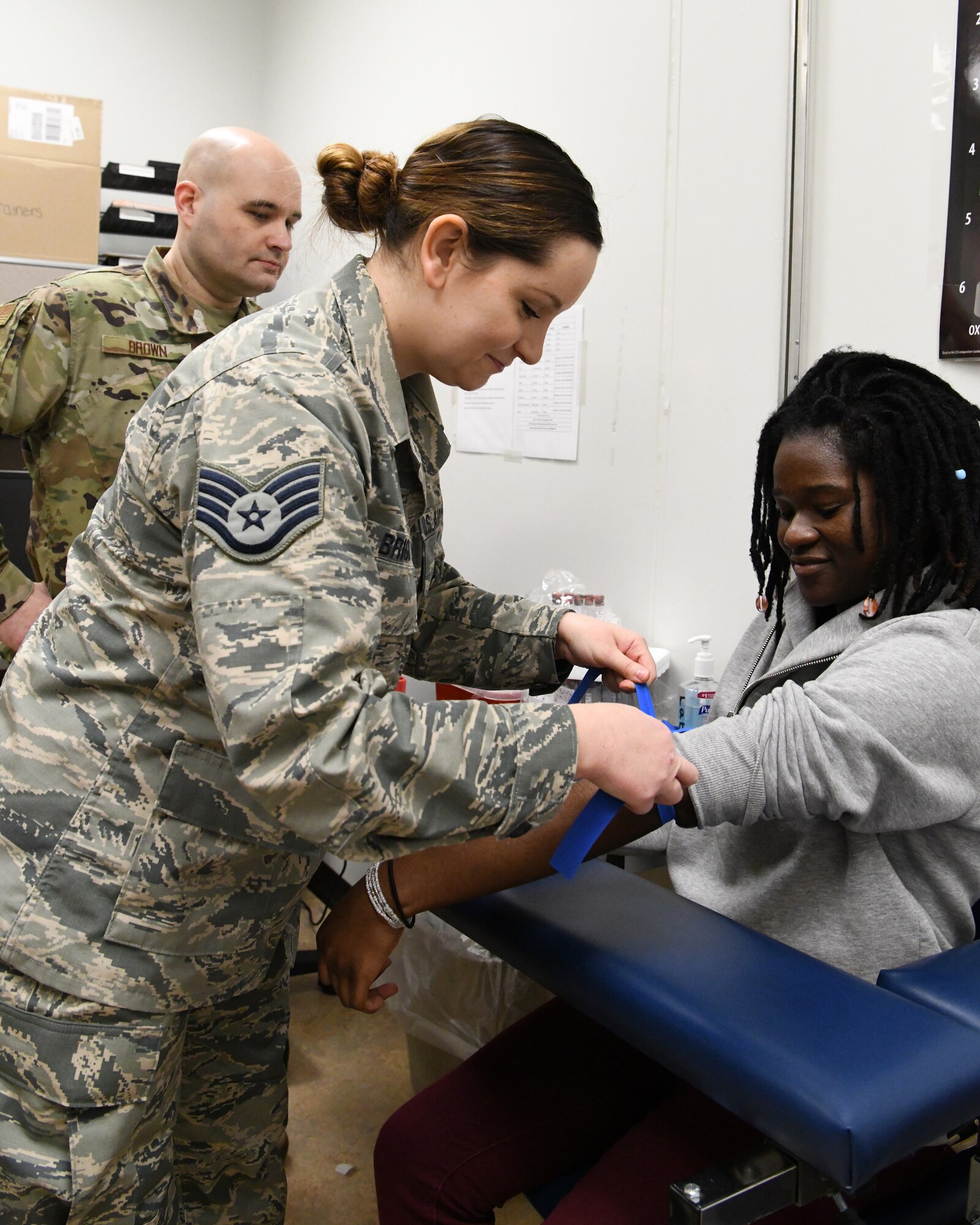 Chief Master Sgt. Jim Brown, 104th Medical Group Superintendent, works with Staff Sgt. Olivia Briggs, 104 MDG apprentice, to provide medical care. The 104th Medical Group recently got new AFSCs which will give them the opportunity to provide more focused care to Airmen.  (U.S. Air National Guard photo by Airman 1st Class Sara Kolinski)