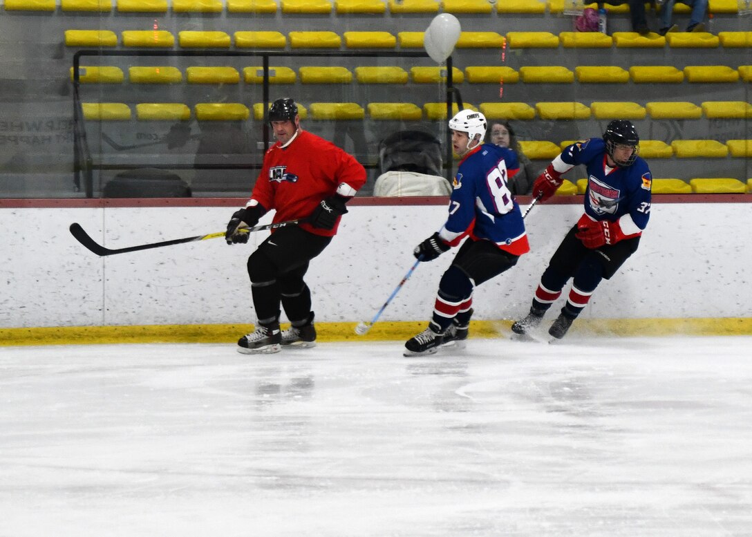 Major Sean Cahill and Tech. Sgt. Nate Poudrier, 104th Fighter Wing Barnestormer players, played hockey against the Springfield Thunderbirds Charity team in order to raise money for an organization aimed at spreading awarness for veteran suicide Feb. 2, 2020, in Westfield, Massachusetts. The hockey game built camaraderie amongst Airmen and allowed them with an opportunity to support military veterans. (U.S. Air National Guard photo by Airman 1st Class Sara Kolinski)