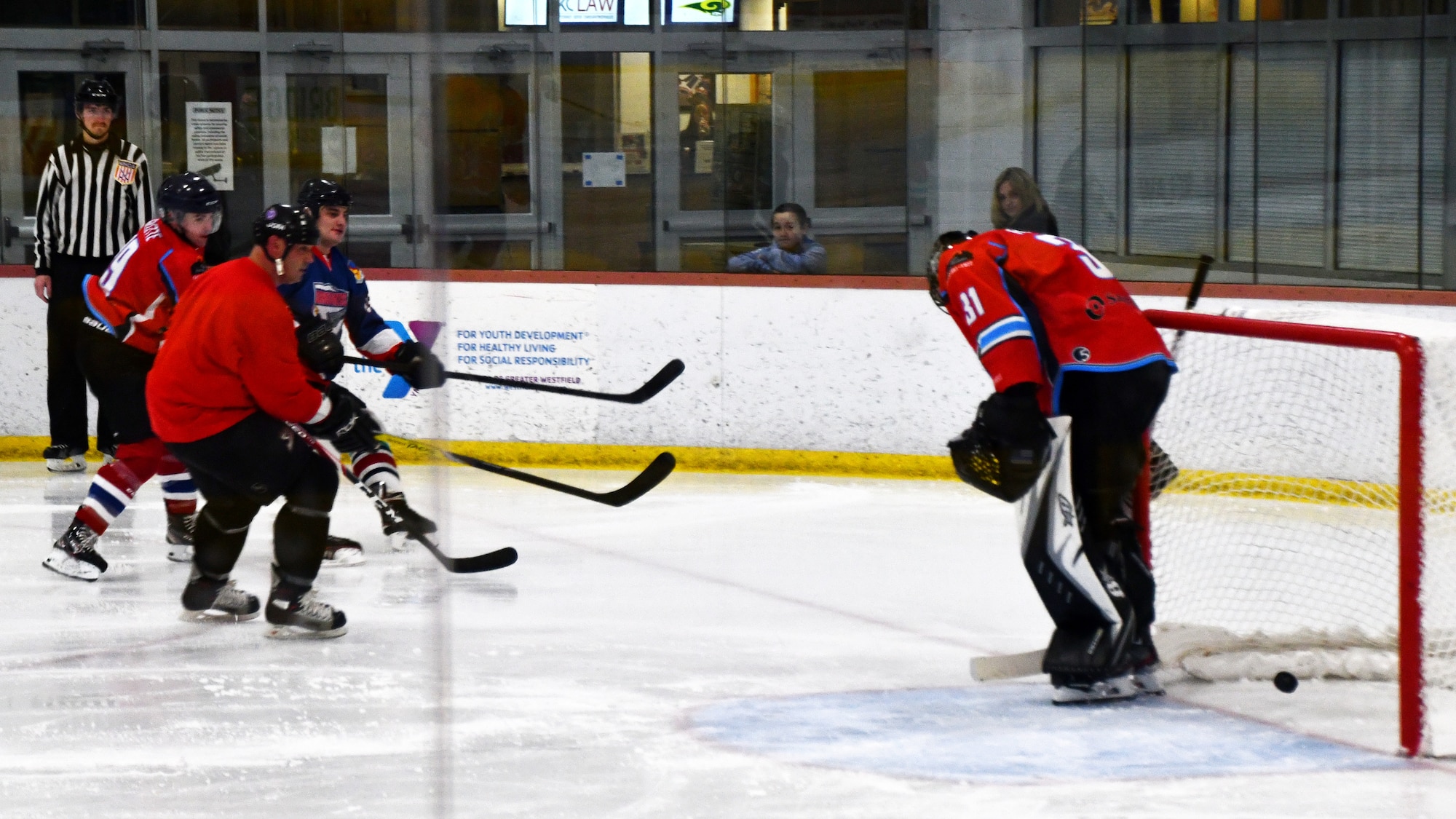 Senior Airman Nick Burns, 104th Fighter Wing Barnestormer player, scores a goal against the Springfield Thunderbirds Charity team in a game to raise money for an organization aimed at spreading awarness for veteran suicide Feb. 2, 2020, in Westfield, Massachusetts. The hockey game built camaraderie amongst Airmen and allowed them with an opportunity to support military veterans. (U.S. Air National Guard photo by Airman 1st Class Sara Kolinski)