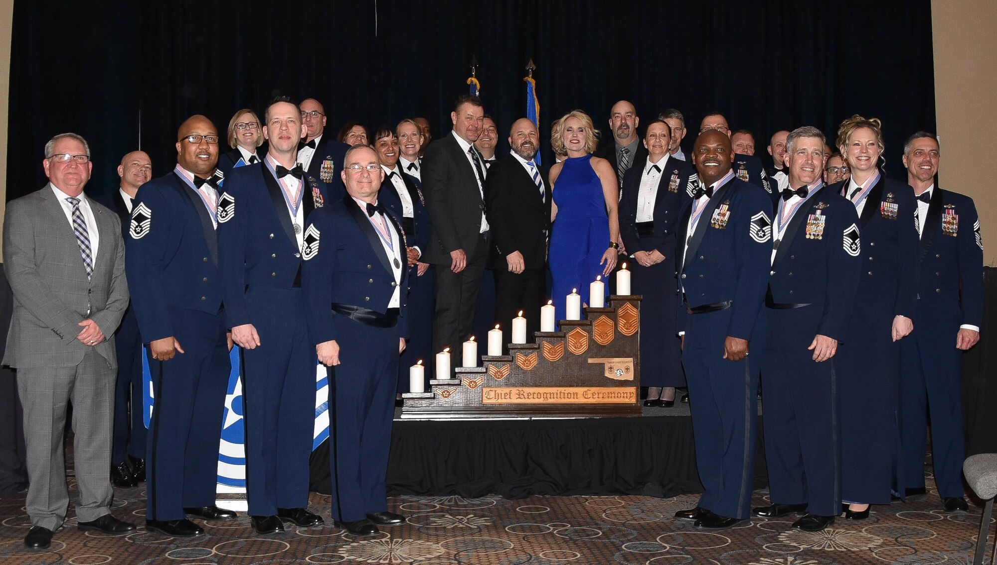 The newest Chief Master Sergeant inductees are honored by Tinker Air Force Base top leadership at the Reed Event Center, Midwest City, Oklahoma on Feb. 29. The newest inductees (left to right) include Chief Master Sgt.  Alphonzo Glover, 513th Maintenance Squadron, Chief Master Sgt. Select Hubert Drake, Head Quarters Air Force Flight Standards Agency,  Chief Master Sgt. Shaun Stone, 552nd Air Control Wing, Chief Master Sgt. Carvelle Jones, 552nd Aircraft Maintenance Squadron, Chief Master Sgt. Select Dustin Johnson, 552nd Operations Support Squadron and Chief Master Sgt. Select Lindsey Wolf, 72nd Air Base Wing. In the 2019 promotion cycle, 530 out of 2,529 eligible senior master sergeants were selected for promotion, with the average time in service of 21.4 years. Those selected began promoting Jan. 1 in accordance to their promotion sequence number (U.S. Air Force Photo by 2nd Lt. Ashlyn K. Paulson).