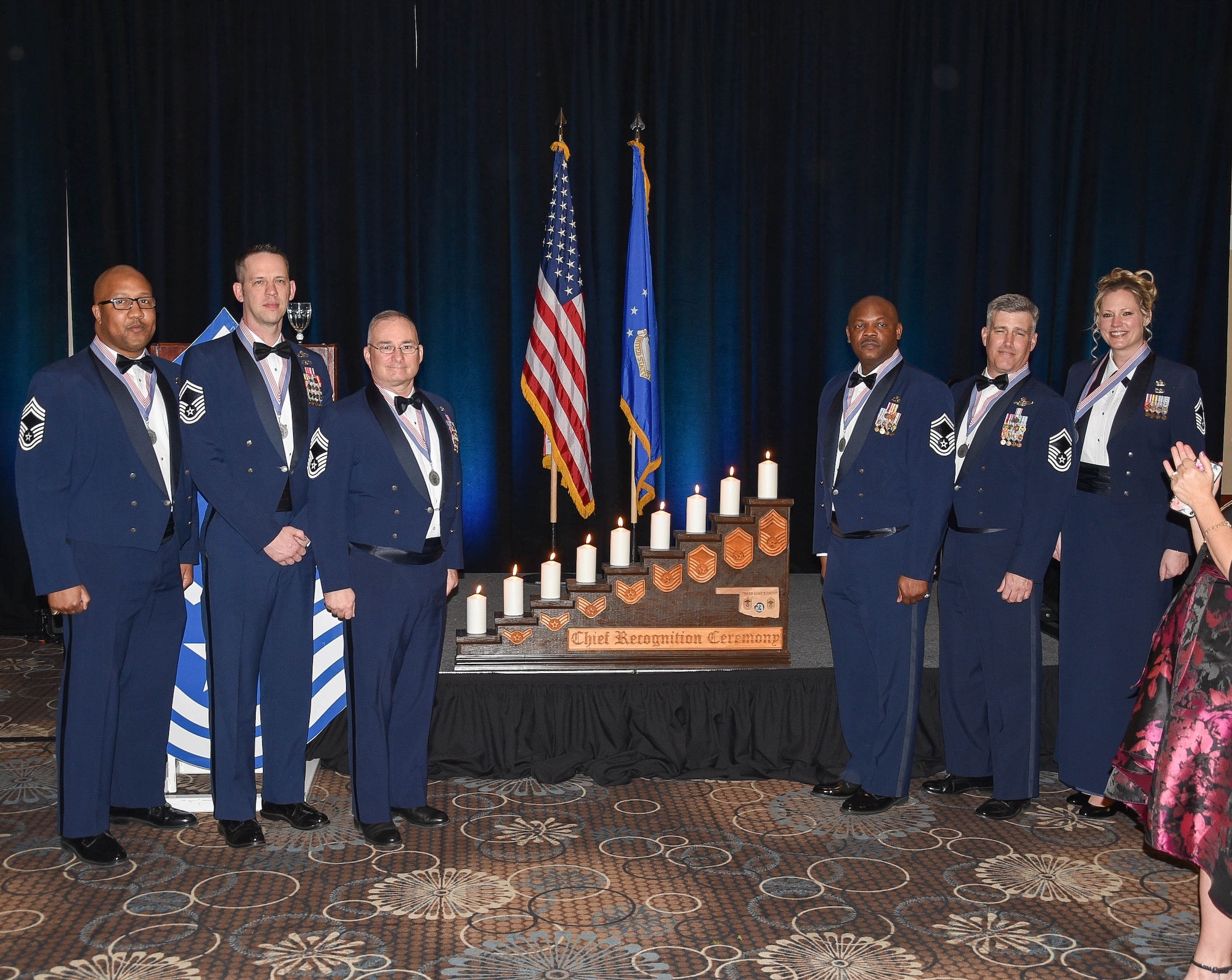 The newest Chief Master Sergeant inductees are honored by Tinker Air Force Base top leadership at the Reed Event Center, Midwest City, Oklahoma on Feb. 29. The newest inductees (left to right) include Chief Master Sgt.  Alphonzo Glover, 513th Maintenance Squadron, Chief Master Sgt. Select Hubert Drake, Head Quarters Air Force Flight Standards Agency,  Chief Master Sgt. Shaun Stone, 552nd Air Control Wing, Chief Master Sgt. Carvelle Jones, 552nd Aircraft Maintenance Squadron, Chief Master Sgt. Select Dustin Johnson, 552nd Operations Support Squadron and Chief Master Sgt. Select Lindsey Wolf, 72nd Air Base Wing. In the 2019 promotion cycle, 530 out of 2,529 eligible senior master sergeants were selected for promotion, with the average time in service of 21.4 years. Those selected began promoting Jan. 1 in accordance to their promotion sequence number (U.S. Air Force Photo by 2nd Lt. Ashlyn K. Paulson).