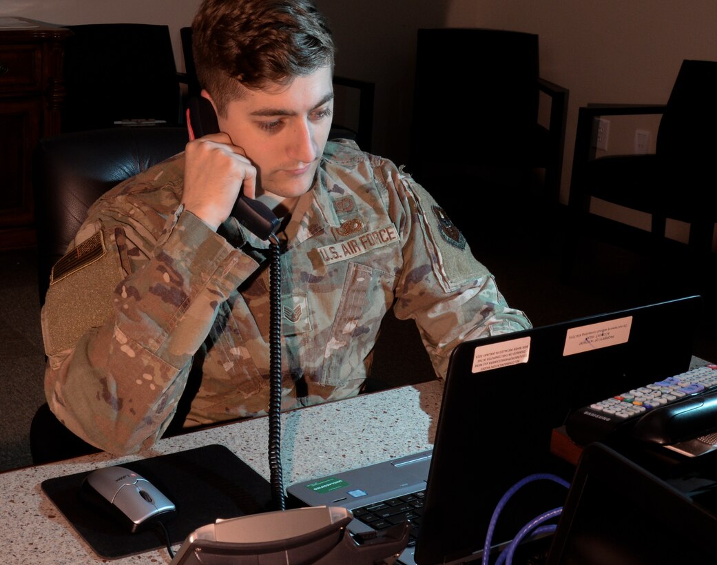 Staff Sgt. Aaron Ellis, 14th Wing Staff Agency command and control systems NCOIC, makes a phone call, Feb. 25, 2020, at Columbus Air Force Base, Mississippi. The command post team at Columbus Air Force Base is responsible for alerting, directing and reporting any threat, at all times, for 24 hours, 7 days a week, 365 days a year. (U.S. Air Force photo by Airman Davis Donaldson)