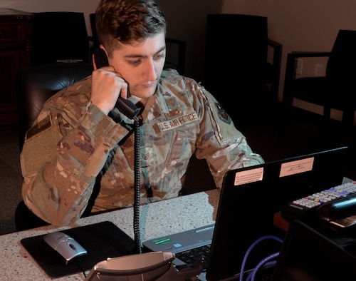 Staff Sgt. Aaron Ellis, 14th Wing Staff Agency command and control systems NCOIC, makes a phone call, Feb. 25, 2020, at Columbus Air Force Base, Mississippi. The command post team at Columbus Air Force Base is responsible for alerting, directing and reporting any threat, at all times, for 24 hours, 7 days a week, 365 days a year. (U.S. Air Force photo by Airman Davis Donaldson)