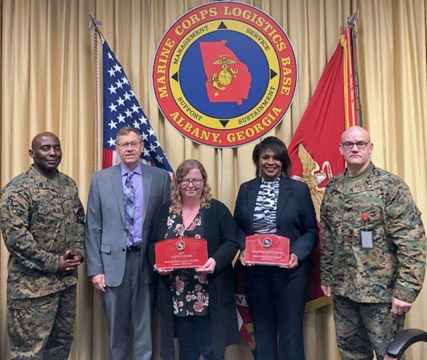 From left to right, Marine Corps Logistics Base Albany Sgt. Maj. Jeffrey Young, Executive Director Leonard Housley and Executive Officer Lt. Col. Joseph Ray hand out awards during the Commanding Officer’s Safety Council Feb. 19. Award recipients from left to right, MCCS Safety Officer Alisha Montieth and MCCS Director Deborah Bouyer received the CO’s Safety Division CY19 Award for the 4th Quarter and the CY19 Award of the Year. (U.S. Marine Corps by Juan Escovar)
