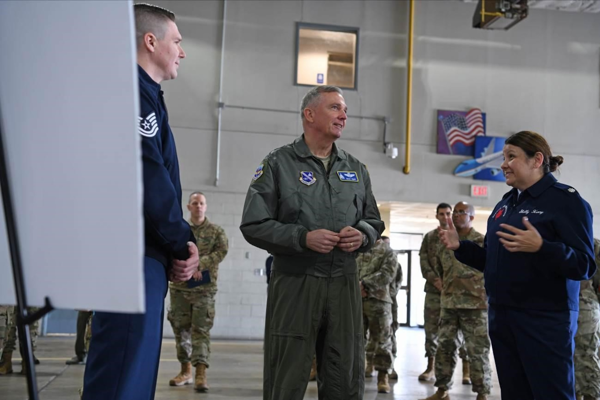 Lt. Col. Shelby Henry, right, 89th Aerial Port Squadron commander, briefs Air Force District of Washington and 320th Air Expeditionary Wing Commander Maj. Gen. Ricky N. Rupp, middle, regarding the activities of her squadron during an 89th Airlift Wing Immersion Tour on Joint Base Andrews, Maryland, Feb. 28, 2020. The 89th APS provides air transportation support for the president, national leaders, combatant commanders, and Special Air Mission operations 24/7. (U.S. Air Force photo by Tech. Sgt. Kentavist P. Brackin)