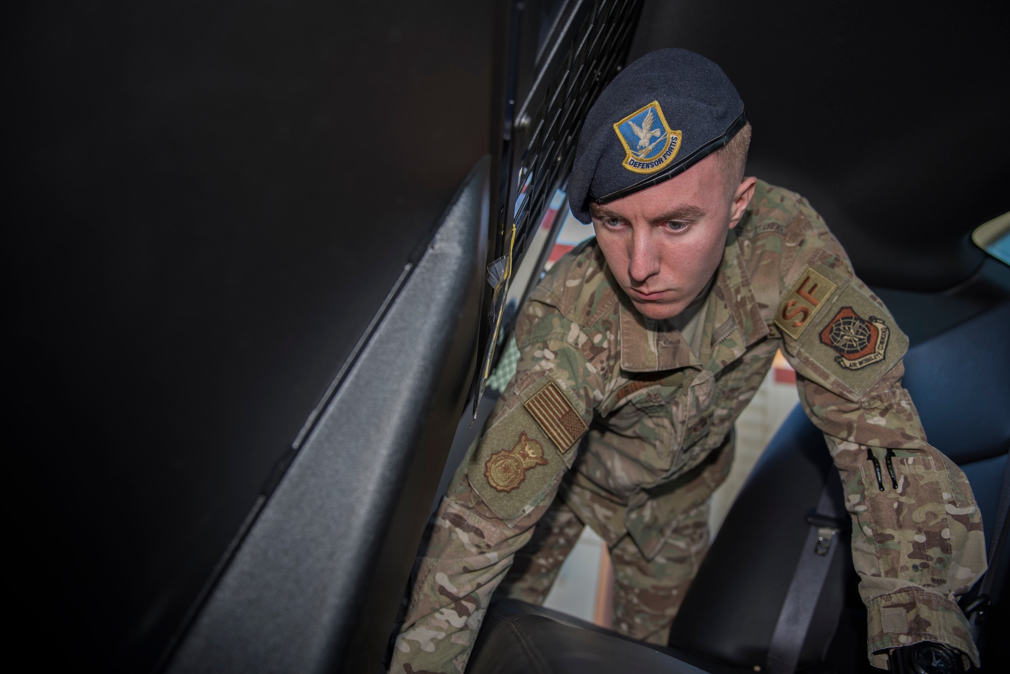 U.S. Air Force Senior Airman Anthony Meinert, 60th Security Forces Squadron installation entry controller, inspects a vehicle March 3, 2020, at Travis Air Force Base, California. Meinert was the Warrior of the Week from March 1-7. The program recognizes Airmen who have made significant contributions to their units. (U.S. Air Force photo by Airman 1st Class Cameron Otte)
