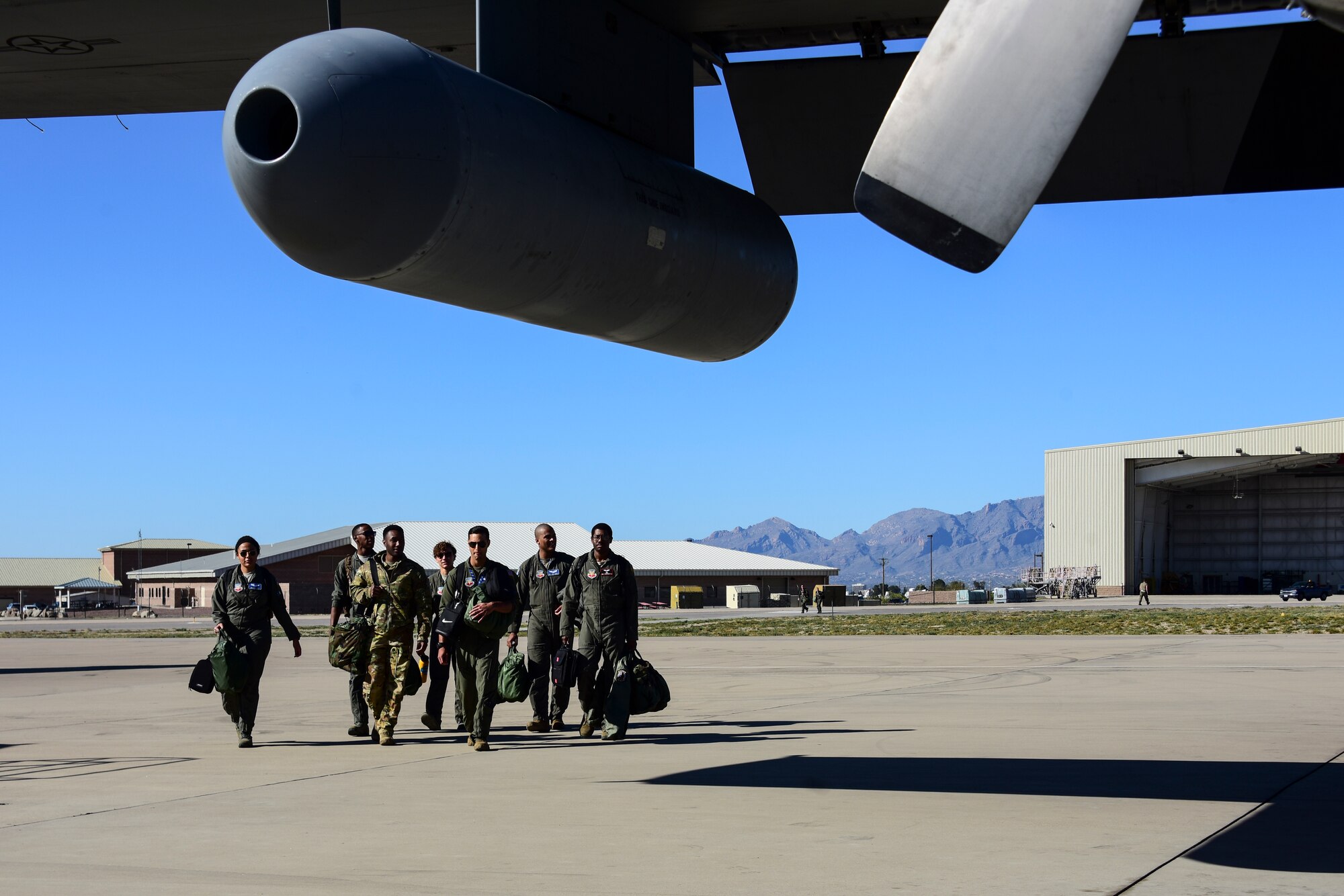 Airmen walk towards aircraft