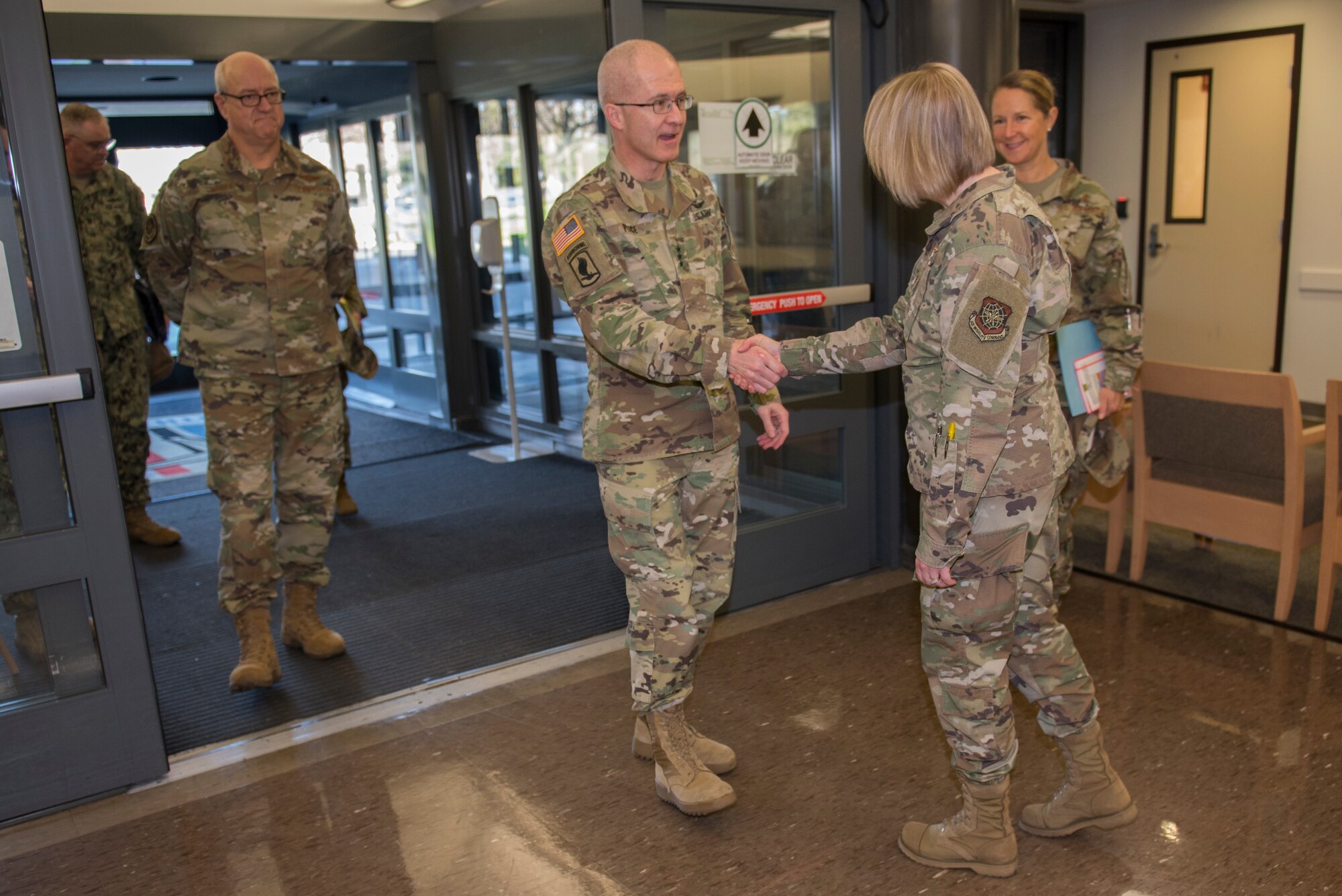 U.S. Air Force Maj. Carrie Lucas, 60th Medical Operations Squadron family medicine faculty, greets U.S. Army Lt. Gen. Ronald J. Place, Defense Health Agency director, Feb. 27, 2020, at Travis Air Force Base, California. Place met with the 60th Medical Group leaders, external partners and staff, and he held a town hall in which he discussed his four priorities and answered questions from the audience. (U.S. Air Force photo by Airman 1st Class Cameron Otte)