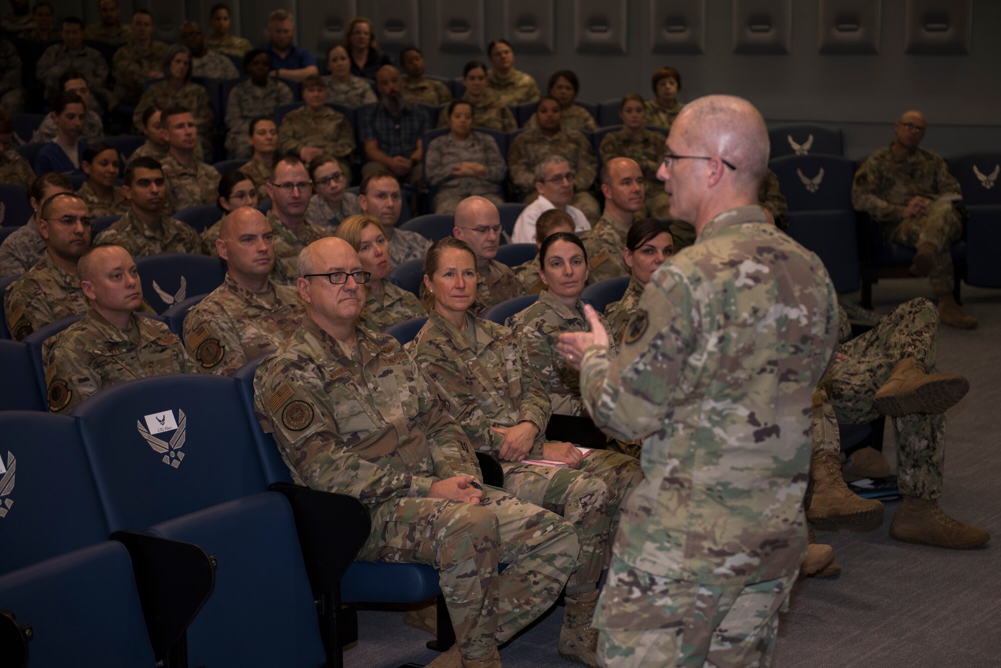 U.S. Army Lt. Gen. Ronald J. Place, Defense Health Agency director, speaks to David Grant Medical USAF Center personnel during a town hall meeting Feb. 27, 2020, at Travis Air Force Base, California. During the town hall, Place discussed the connection between having a medically ready force, a ready medical force, satisfied patients and a fulfilled staff, and took questions from staff. (U.S. Air Force photo by Airman 1st Class Cameron Otte)