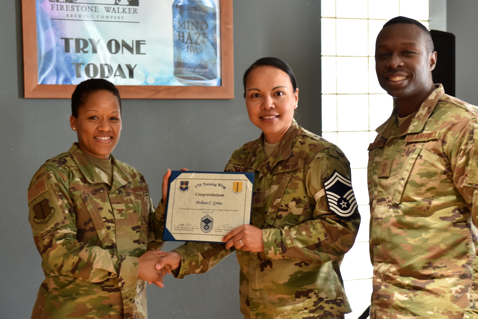 U.S. Air Force Col. Lauren Bryd, 17th Medical Group commander, presents Senior Master Sgt. select Melissa Grino, 17th Operational Medical Readiness Squadron dental fight chief, with her certificate indicating her line number during the senior master sgt. release party at the event center on Goodfellow Air Force Base, Texas, March 3, 2020. This year out of 15,544 only 1,184 individuals were selected to progress from the rank of master sgt. to senior master sgt. (U.S. Air Force photo by Senior Airman Seraiah Wolf)
