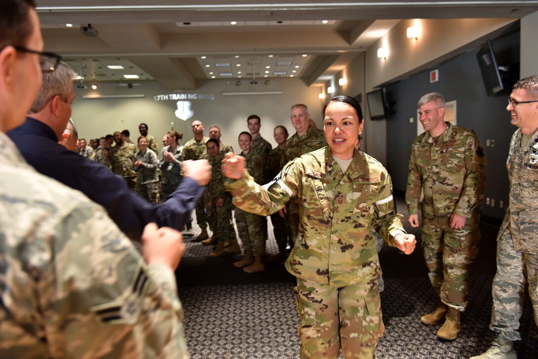 U.S. Air Force Senior Master Sgt. select Melissa Grino, 17th Operational Medical Readiness Squadron dental flight chief, fist bumps coworkers and friends who came to support her during the senior master sgt. release party at the event center on Goodfellow Air Force Base, Texas, March 3, 2020.  Senior master sgt. is in the highest tier of the enlisted rank structure and only one rank away from the highest enlisted rank in the Air Force. (U.S. Air Force photo by Senior Airman Seraiah Wolf)