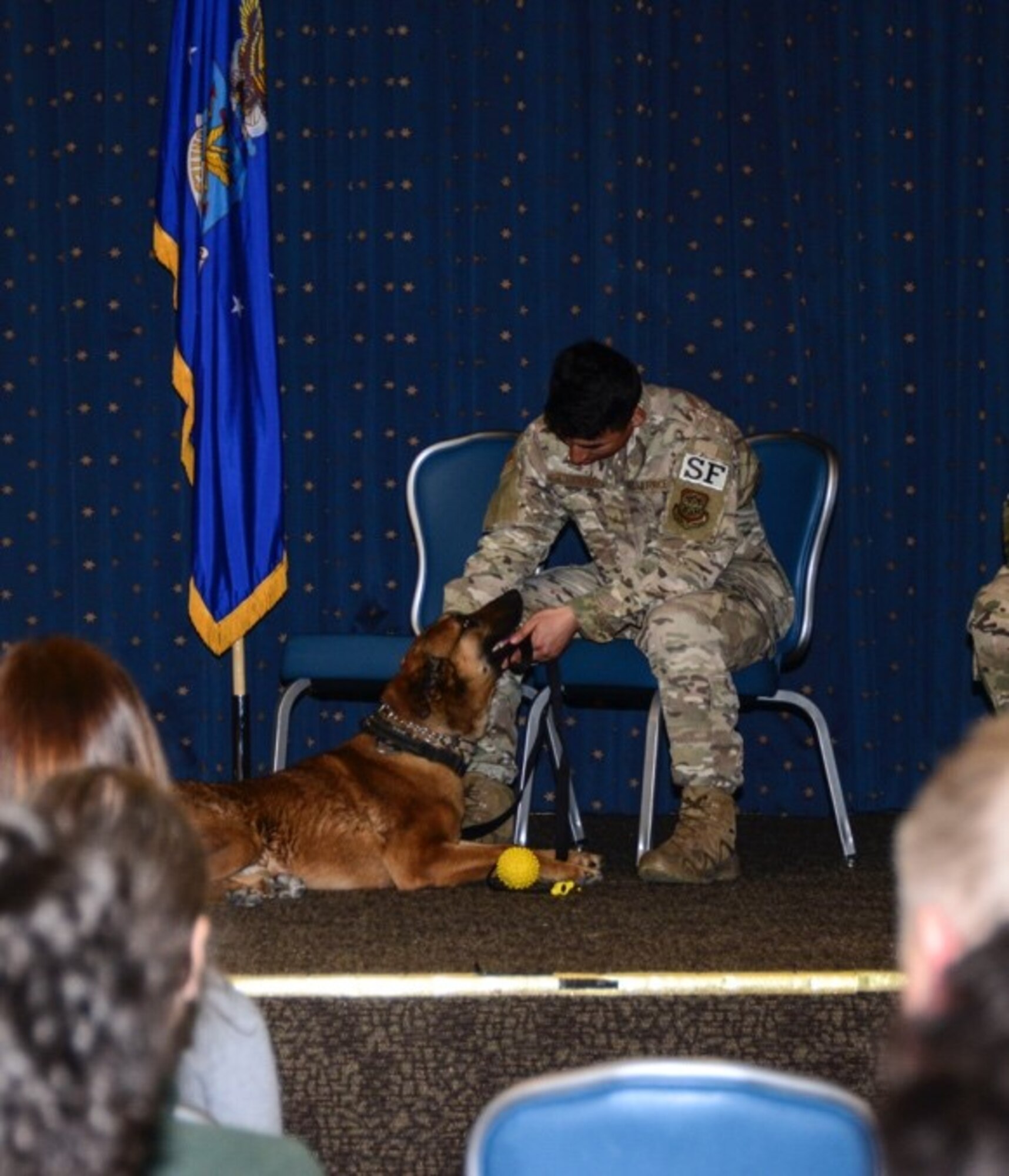Military Working Dog Mex receives some love from his owner after his retirement ceremony.