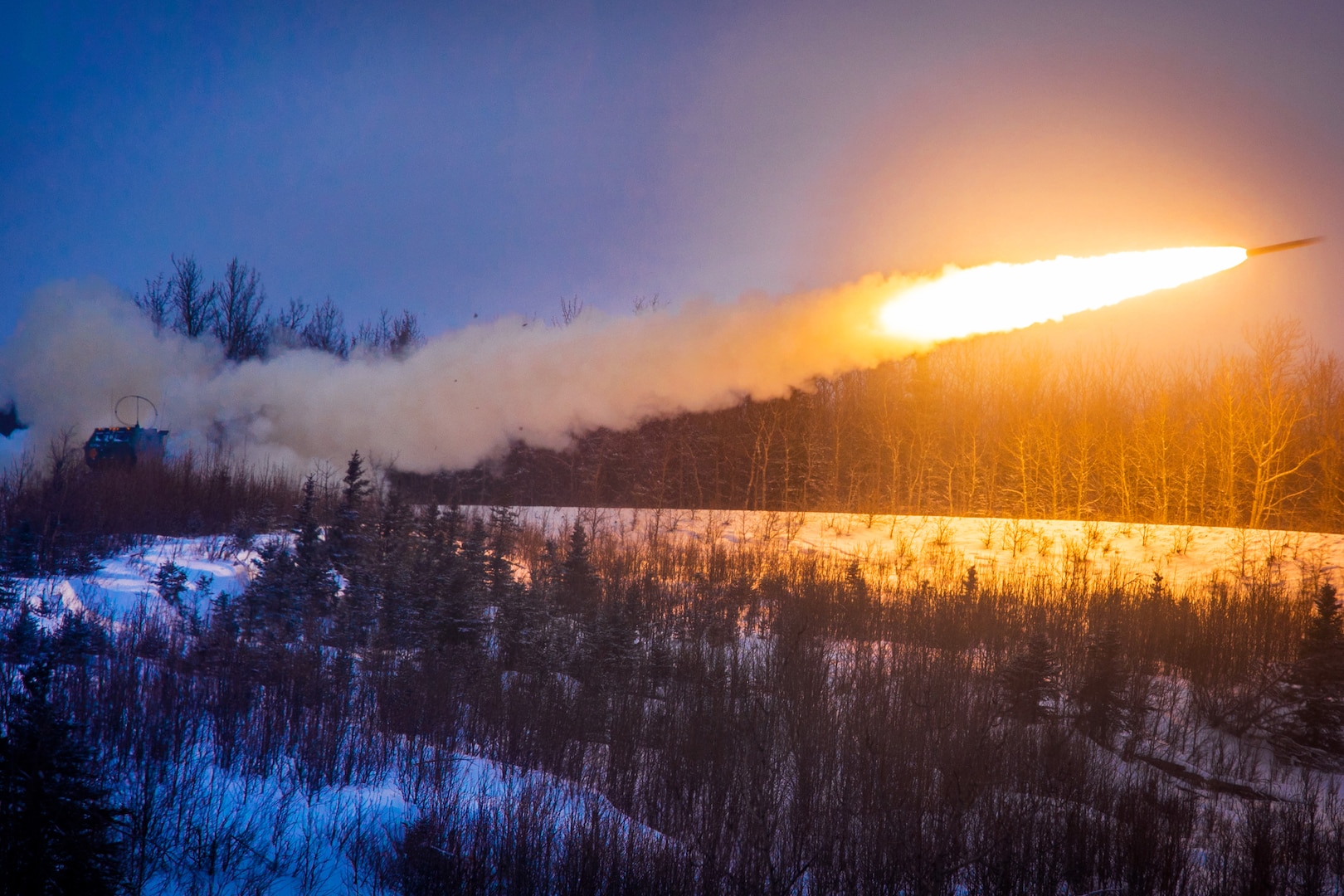 A rocket soars across the night sky.